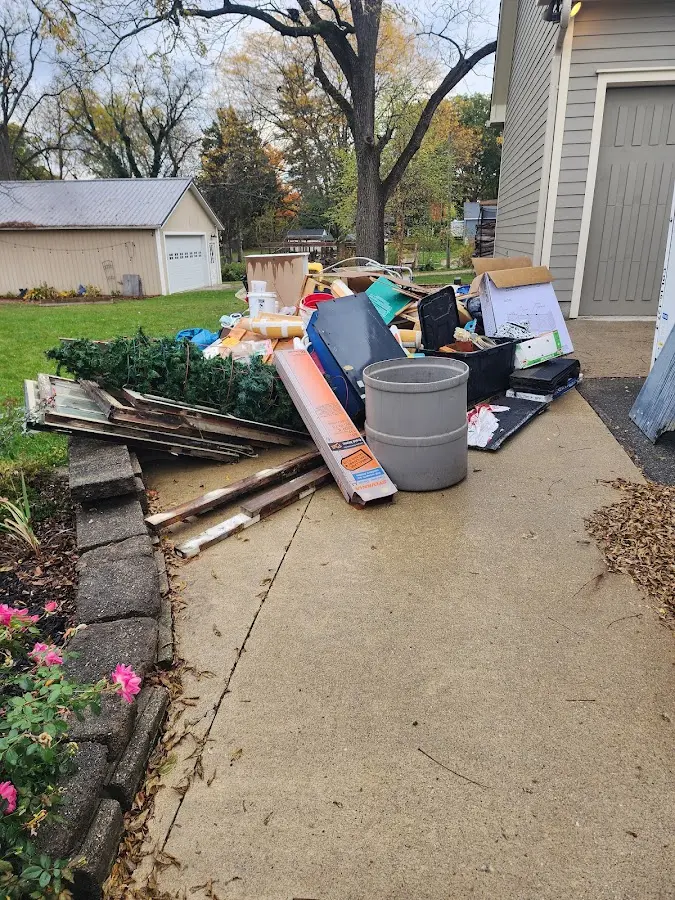 Dumpster being loaded with debris for Demolition Dumpster Rental in London Grove